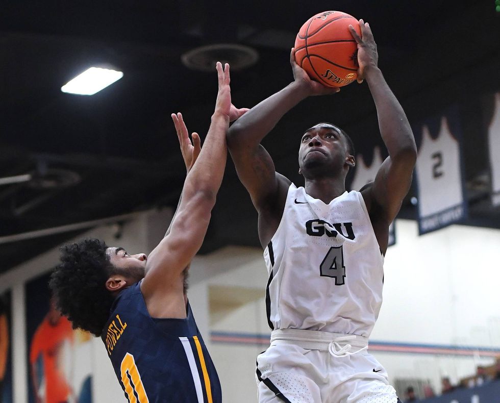 Oscar Frayer #4 of the Grand Canyon Lopes gets by Pookie Powell #0 of the La Salle Explorers for a basket in the first half of the game during the Wooden Legacy Tournament at Titan Gym on November 25, 2018 in Fullerton, California.