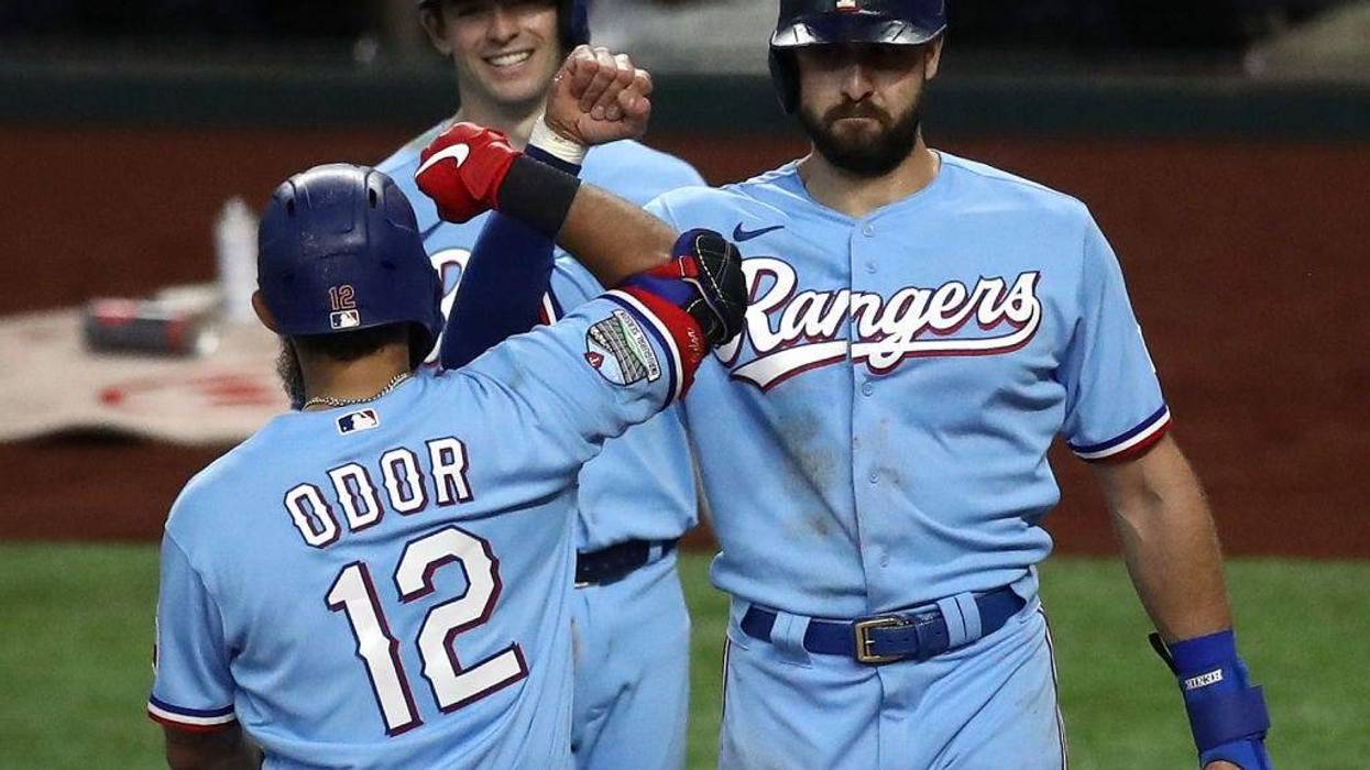 ougned Odor #12 of the Texas Rangers celebrates a three-run home run with Joey Gallo #13 and Nick Solak #15 against the Houston Astros in the fourth inning at Globe Life Field.