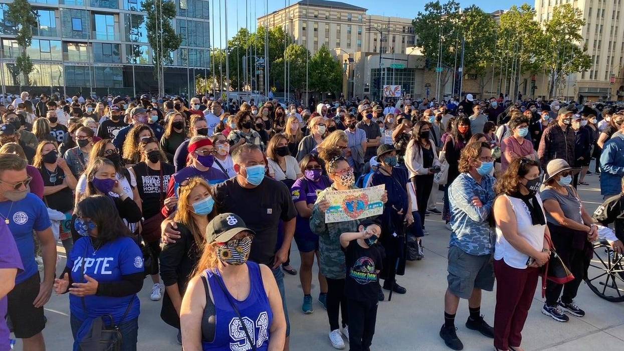 Over a thousand people gather outside San Jose City Hall to mourn the nine lives lost at Wednesday's mass shooting at the Valley Transportation Authority rail yard, May 27, 2021.