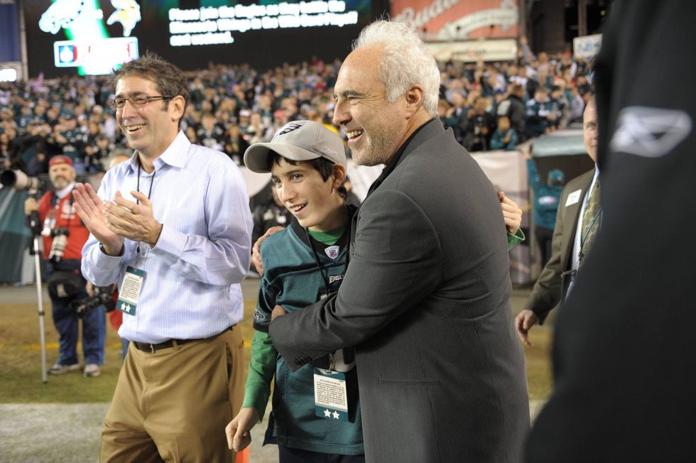 Owner Jeffrey Lurie of the Philadelphia Eagles hugs his son Julian after the game against the Dallas Cowboys on Dec. 28, 2008, at Lincoln Financial Field in Philadelphia, Pennsylvania.