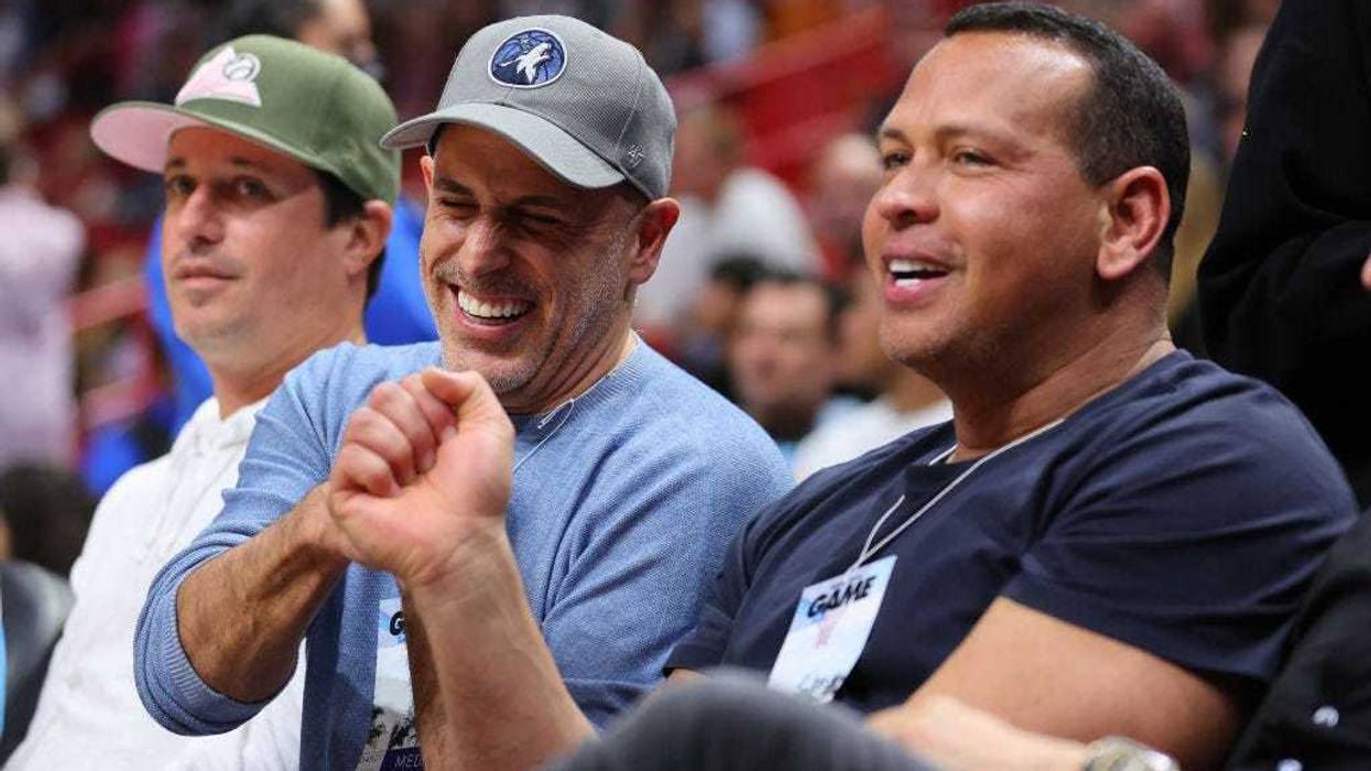 Owners Marc Lore and Alex Rodriguez of the Minnesota Timberwolves fist bump after the Minnesota Timberwolves defeated the Miami Heat at FTX Arena on March 12, 2022 in Miami, Florida.