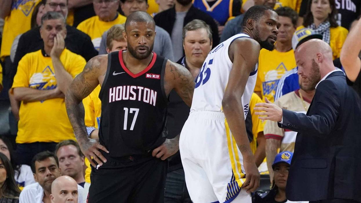 P.J. Tucker of the Houston Rockets watches as Kevin Durant of the Golden State Warriors limps off with a calf injury.