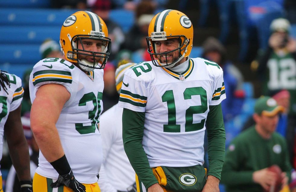 Packers quarterback Aaron Rodgers with his former teammate, John Kuhn.