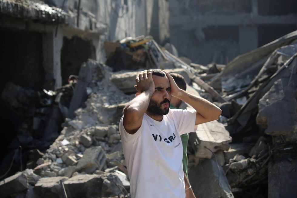 Palestinian citizens in Gaza City inspect damage to their homes caused by Israeli airstrikes on Thursday.