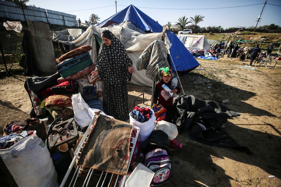 Palestinians are seen in the makeshift Al-Mawasi camp for displaced people west of Khan Yunis in the southern Gaza Strip on March 10, 2024.