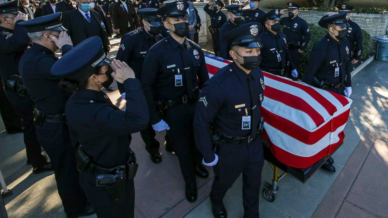 Pallbearers carry the casket at the funeral services of LAPD Officer Fernando Arroyos at Forest Lawn Hollywood Hills on February 2, 2022 in Los Angeles, California.