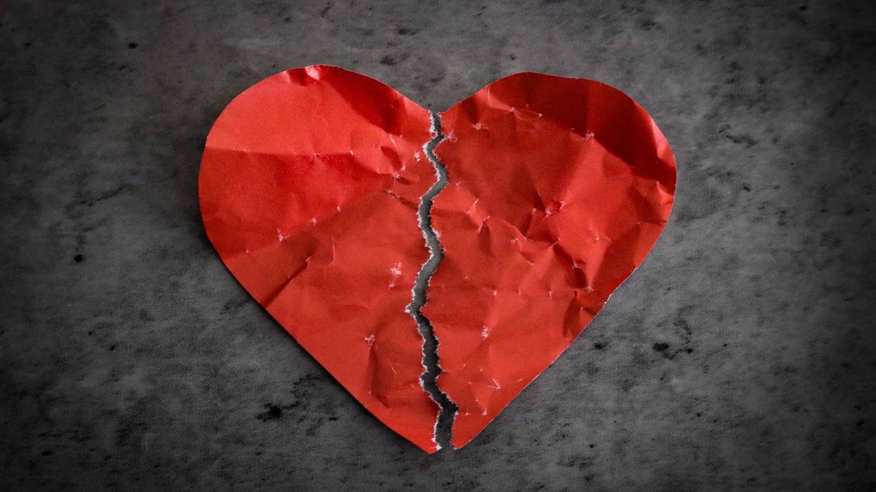Paper heart ripped in half.