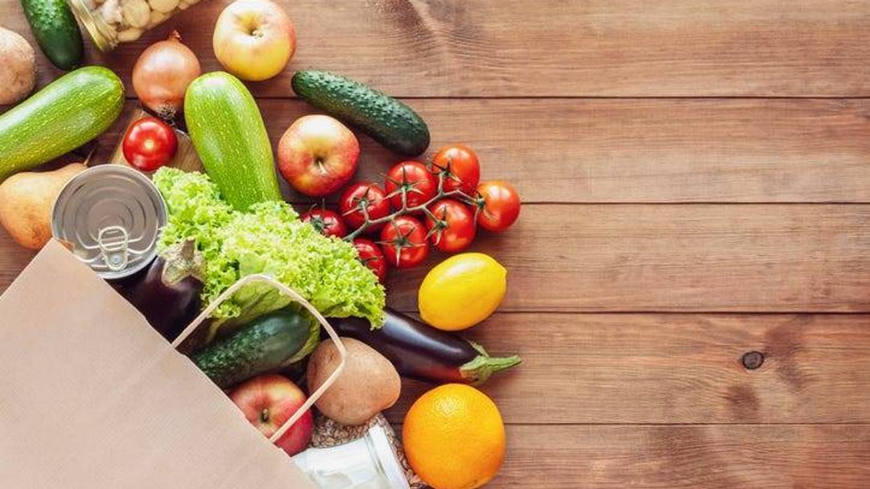 Paper shopping food bag with grocery and vegetables