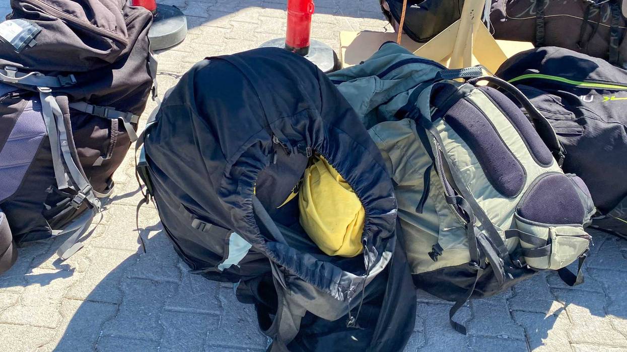 Parachute backpacks for extreme skydiving lie on the ground.