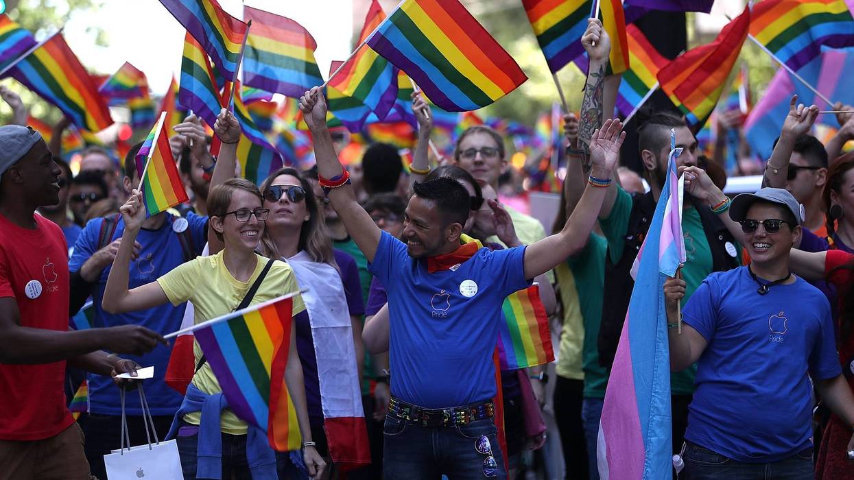 Parade participants wave pride flags as the march during the 2016 San Francisco Pride Parade on June 26, 2016 in San Francisco, California.