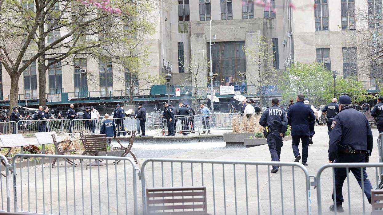 Paramedics attend to a person who lit themselves on fire near Manhattan Criminal Court on April 19, 2024.
