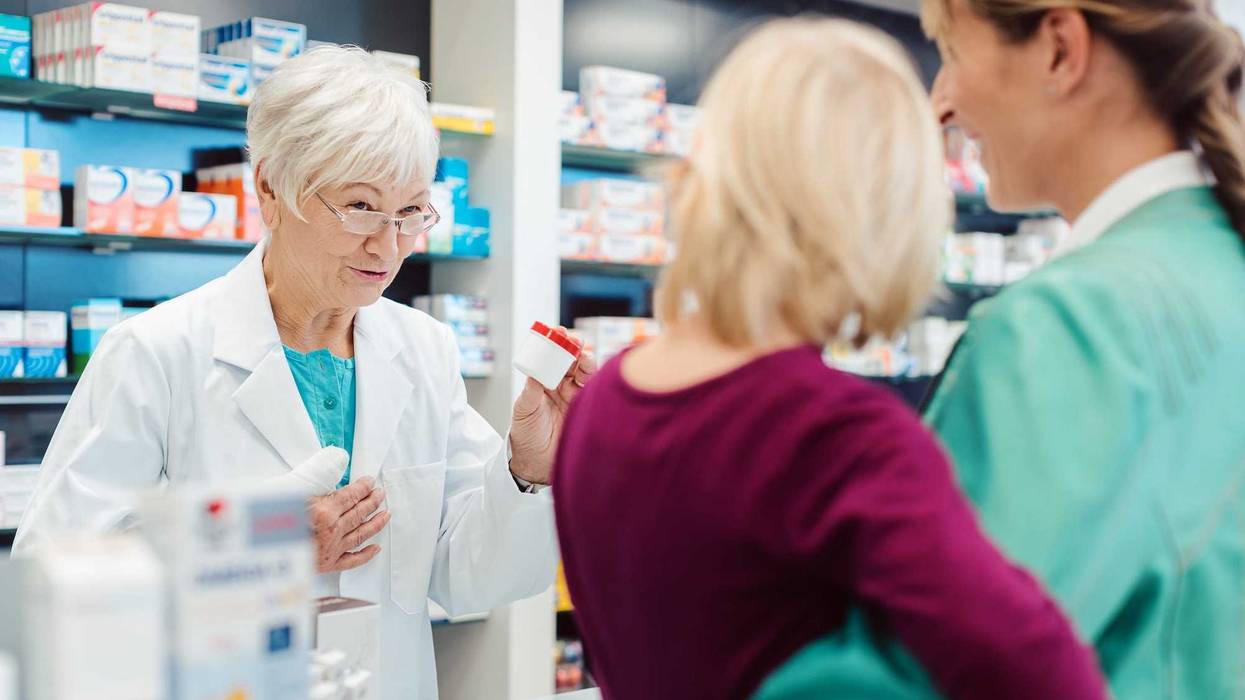 Parent and child at a pharmacy counter.