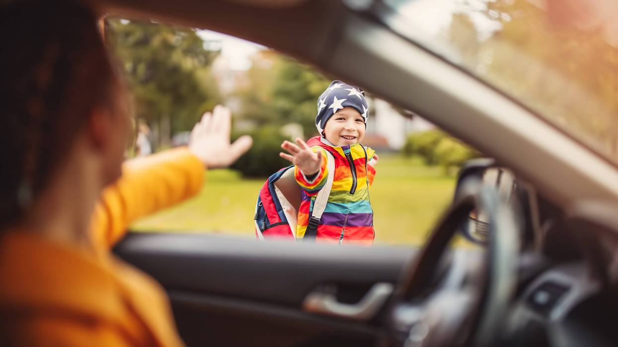 parent waving to kid from car