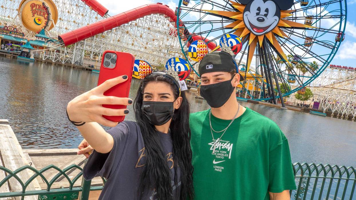 Park visitors hold a phone at the Disneyland Resort in Anaheim, California.