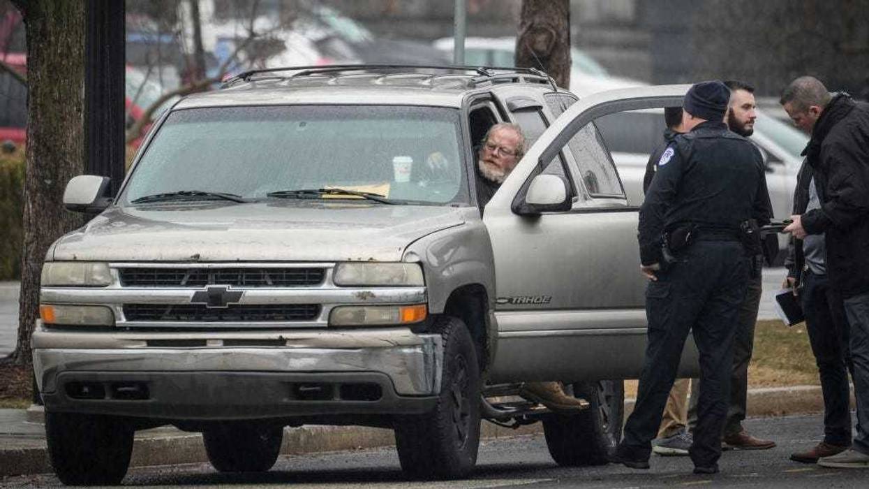 Parked in front of the Supreme Court illegally, Dale Paul Melvin talks with U.S. Capitol Police officers February 3, 2022 in Washington, DC.