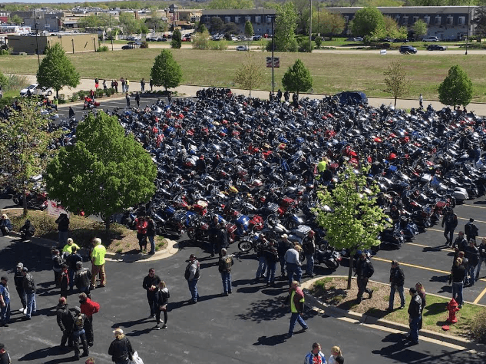 parking lot full of motorcycle riders