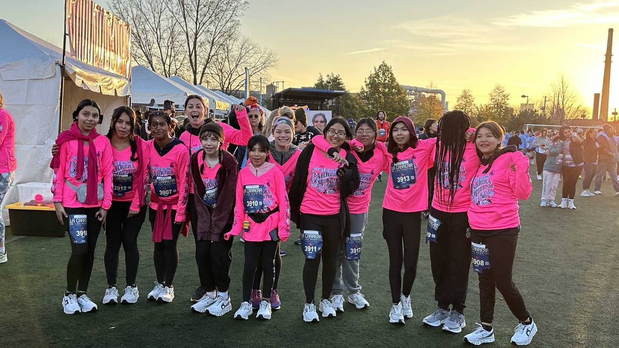Participants of Carrera de los Muertos 2024 pose for a photo. This year's race takes place Nov. 1 at Benito Juarez Community Academy in Pilsen.