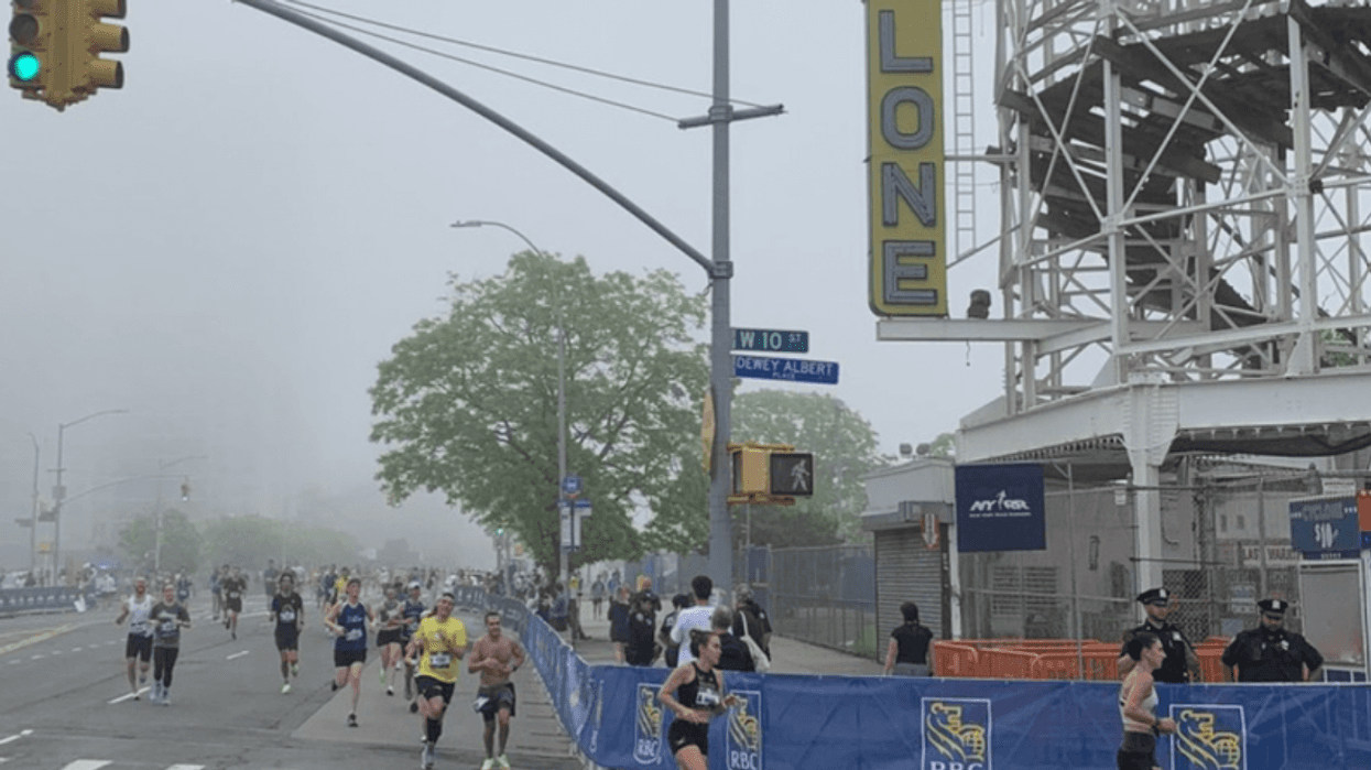 Participants run in the RBC Brooklyn Half Marathon, where fifteen people were injured and one died due to heat.