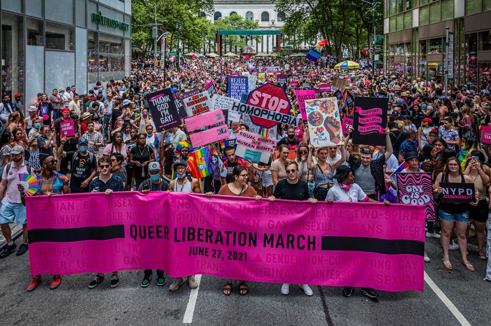 Participants seen marching behind a banner in New York City on June 27, 2021. Thousands of New Yorkers took to the streets of Manhattan to participate on the Reclaim Pride Coalition