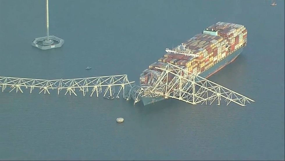Parts of the Francis Scott Key Bridge remain after a container ship collided with one of the bridge