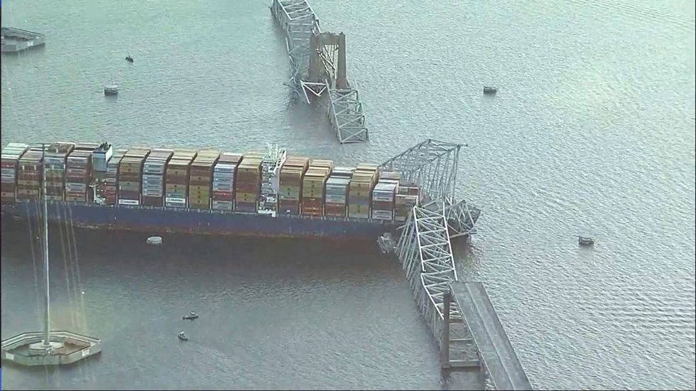 Parts of the Francis Scott Key Bridge remain after a container ship collided with one of the bridge