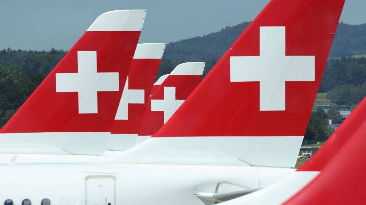 Passenger planes of Swiss airlines stand on the tarmac at Zurich Airport.