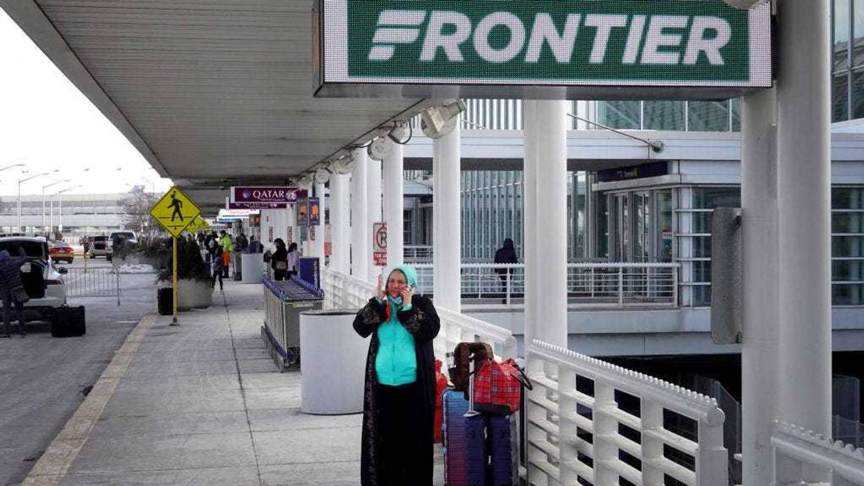 Passengers arrive for flights on Frontier Airlines at O'Hare International Airport on February 07, 2022 in Chicago, Illinois. Frontier has announced a merger with Spirit Airlines, creating what will become the fifth-largest airline in the United States. (Photo by Scott Olson/Getty Images)