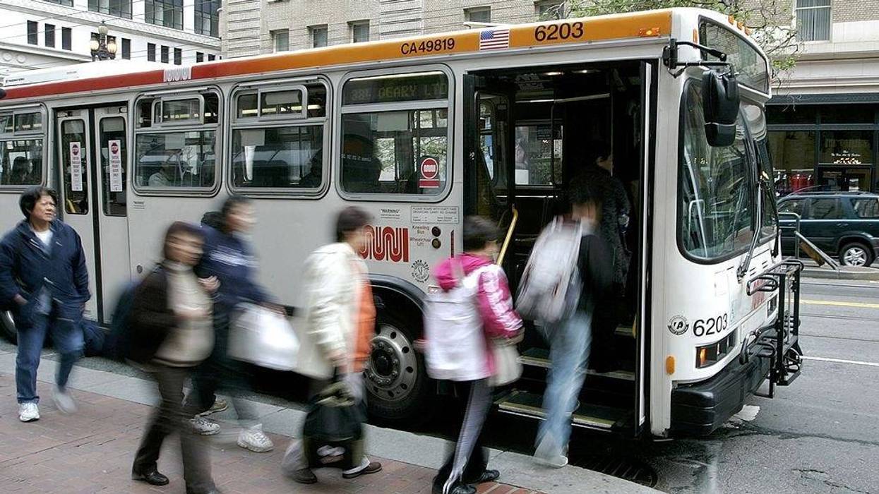 Passengers board a MUNI bus along Market Street April 25, 2006 in San Francisco, California.