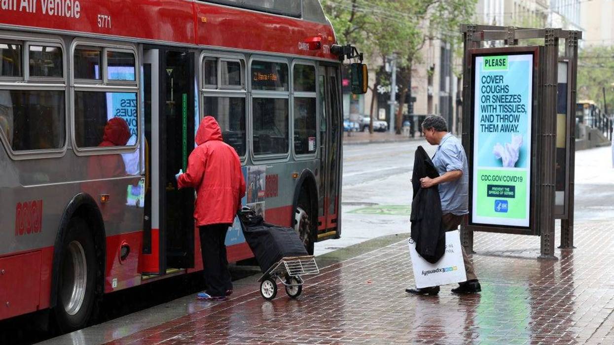 Passengers board a San Francisco MUNI bus during the coronavirus (COVID-19) pandemic on April 06, 2020 in San Francisco, California.