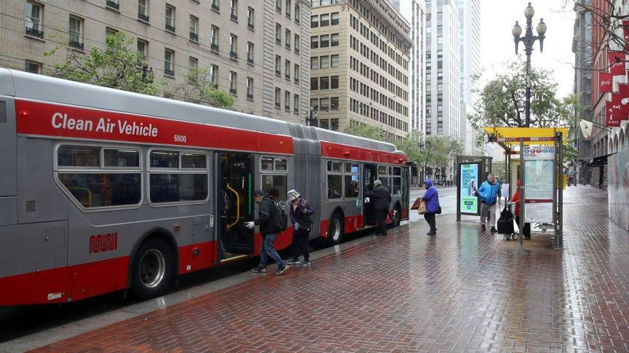 Passengers board a San Francisco MUNI bus during the coronavirus (COVID-19) pandemic on April 06, 2020 in San Francisco, California.