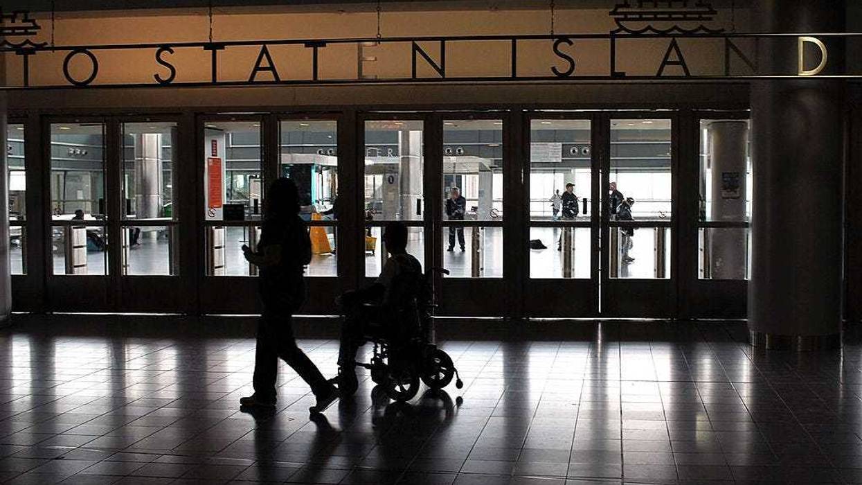Passengers pass the entrance to the Staten Island Ferry on May 8, 2010 in New York City.