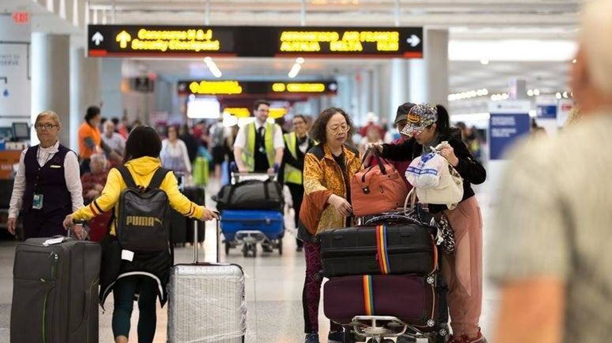 Passengers prepare to check in at Miami International Airport