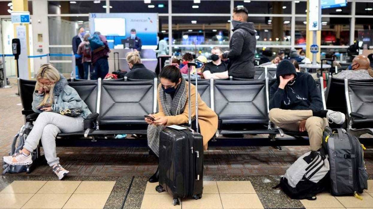 Passengers wait to board an American Airlines flight to Dallas at the Ronald Reagan Washington National Airport on November 24, 2021 in Arlington, Virginia. FAA expects the number of travelers for Thanksgiving to reach pre-pandemic levels, with more than 53 million people traveling in total in the days leading up to the holiday.