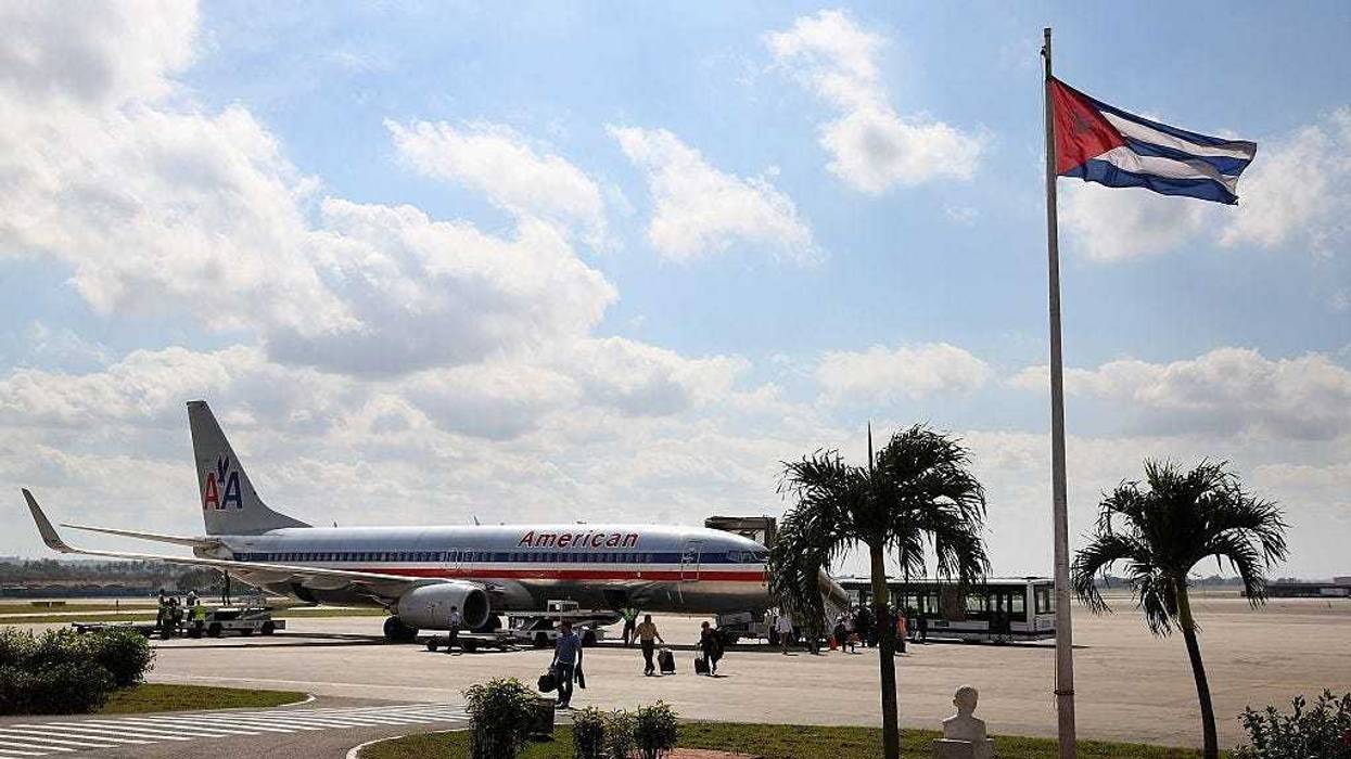 Passengers walk across the tarmac at Jose Marti International Airport after arriving on a charter plane operated by American Airlines January 19, 2015 in Havana, Cuba.