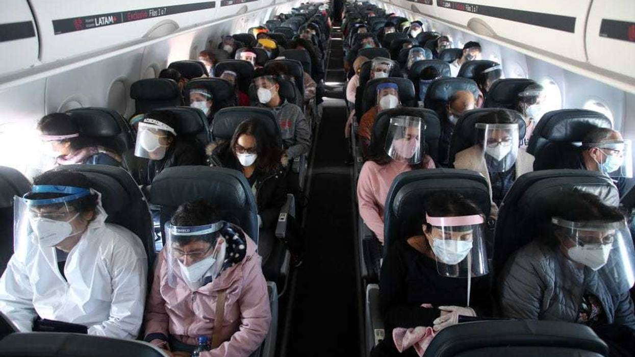 Passengers wearing face shields remain seated during the LA 2212 flight between Lima and Trujillo, Peru on July 15, 2020.