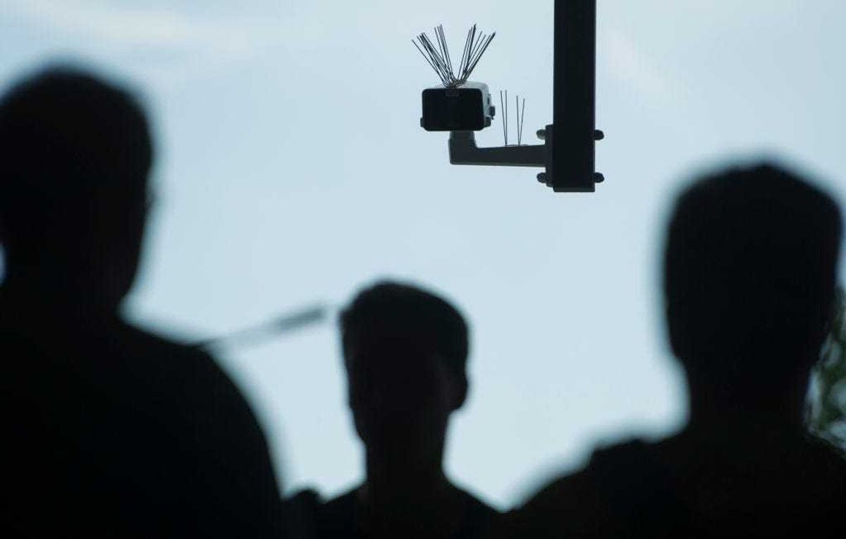 Passersby walk under a surveillance camera which is part of facial recognition technology test at Berlin Suedkreuz station on August 3, 2017 in Berlin, Germany. The technology is claimed could track terror suspects and help prevent future attacks. (Photo by Steffi Loos/Getty Images)