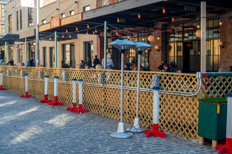 Pastis restaurant prepares electric heaters for their al fresco dining in the Meatpacking District of New York on Thursday, October 8, 2020.