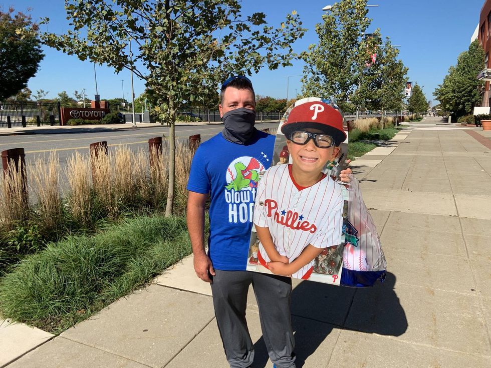 Pat Adare of West Deptford, N.J., holds a cutout of his 7-year-old son, Chase.