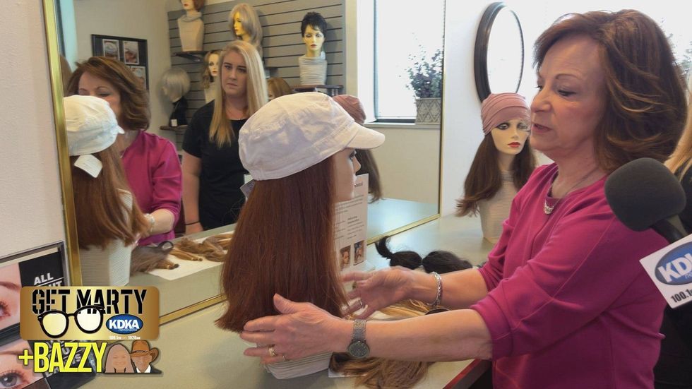 Pat Julkowski shows Arianna Bazzy the Hair Halos they create to help children dealing with hair loss.