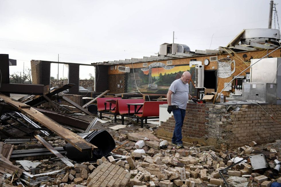 Pat Smith looks through his restaurant, Matador Diner, after a tornado,