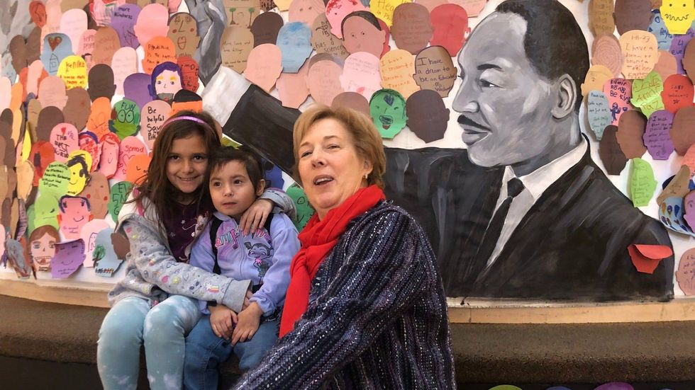 Patricia Wellenbach with the Please Touch Museum poses with two girls who contributed to the Martin Luther King-inspired mural.