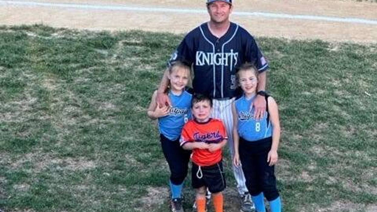 Patrick, coaching at Community Night for North Penn, stands with his kids on the field before the game