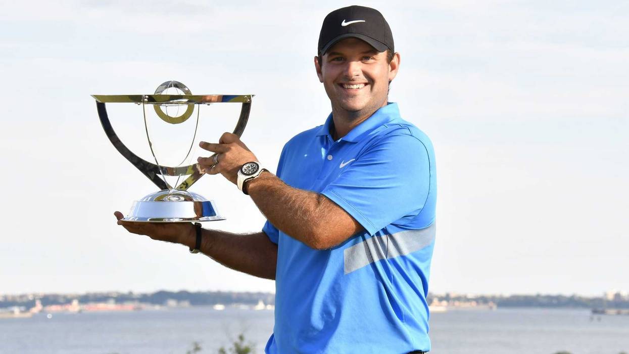 Patrick Reed poses with the winners trophy after winning The Northern Trust