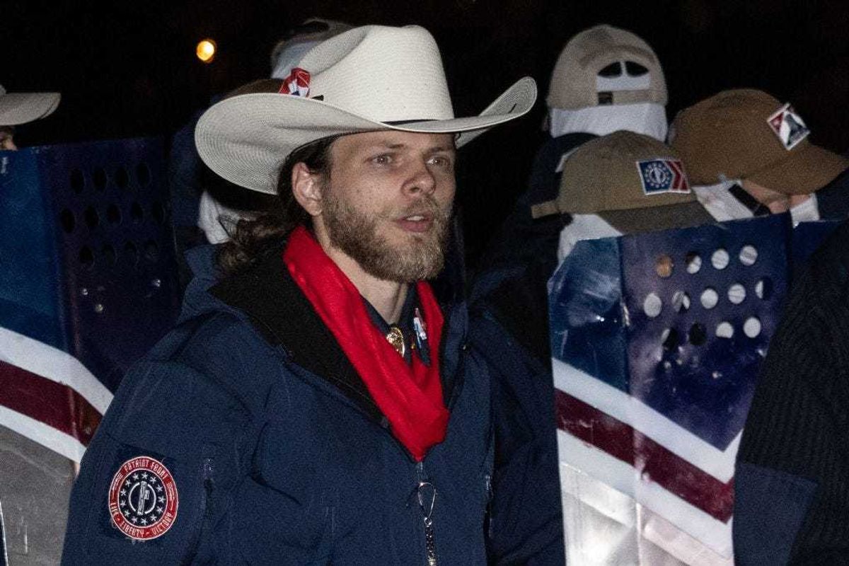 Patriot Front founder Thomas Rousseau waits along the George Washington Parkway near Arlington Cemetery after the group marched on the National Mall on December 04, 2021 in Arlington, Virginia.