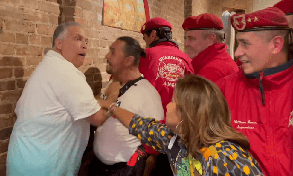 Patrons and members of the Guardian Angels, including Republican mayoral candidate Curtis Sliwa, attempt to break up a fight Friday night at Il Piccolo Buffalo in Little Italy.