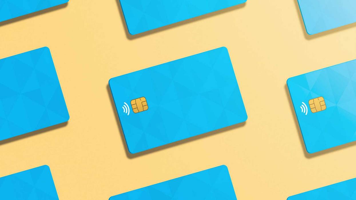 Pattern of realistic credit cards in light orange background.