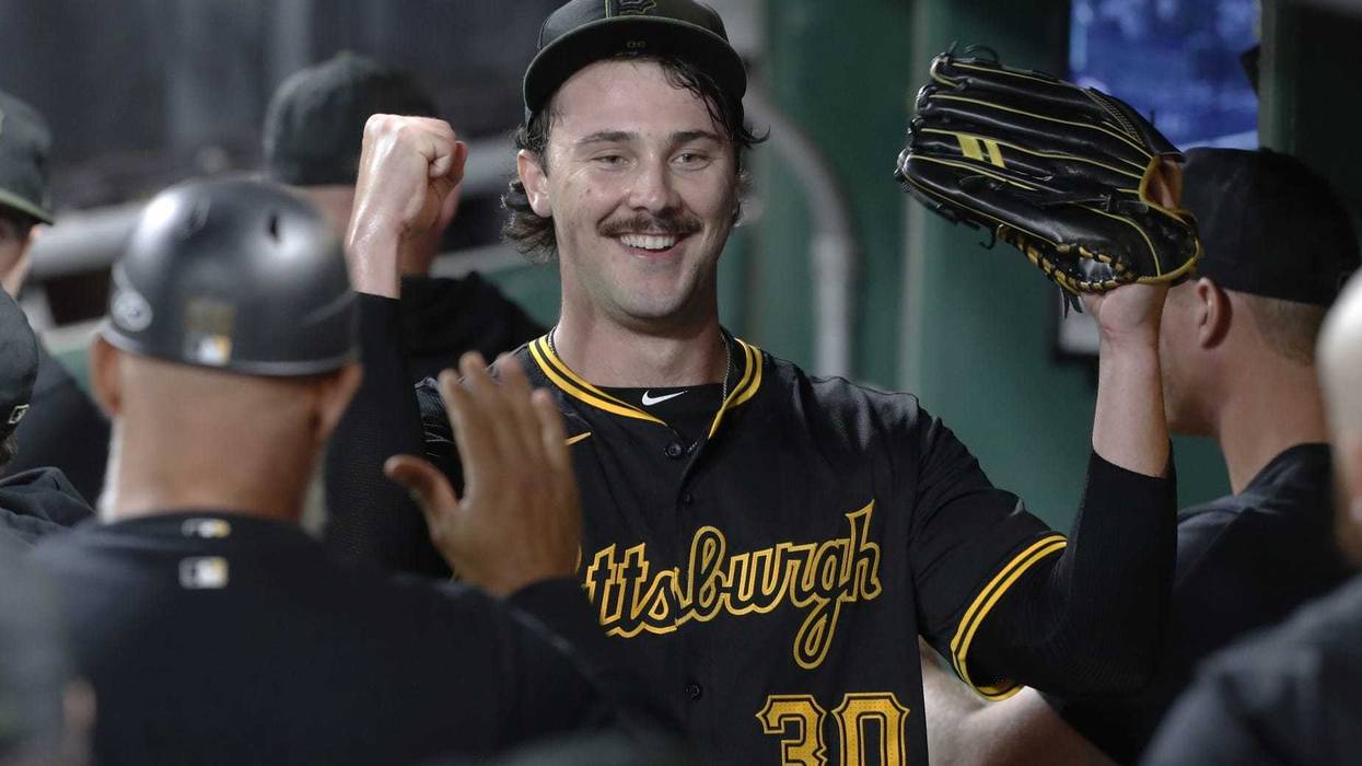 Paul Skenes celebrating in dugout
