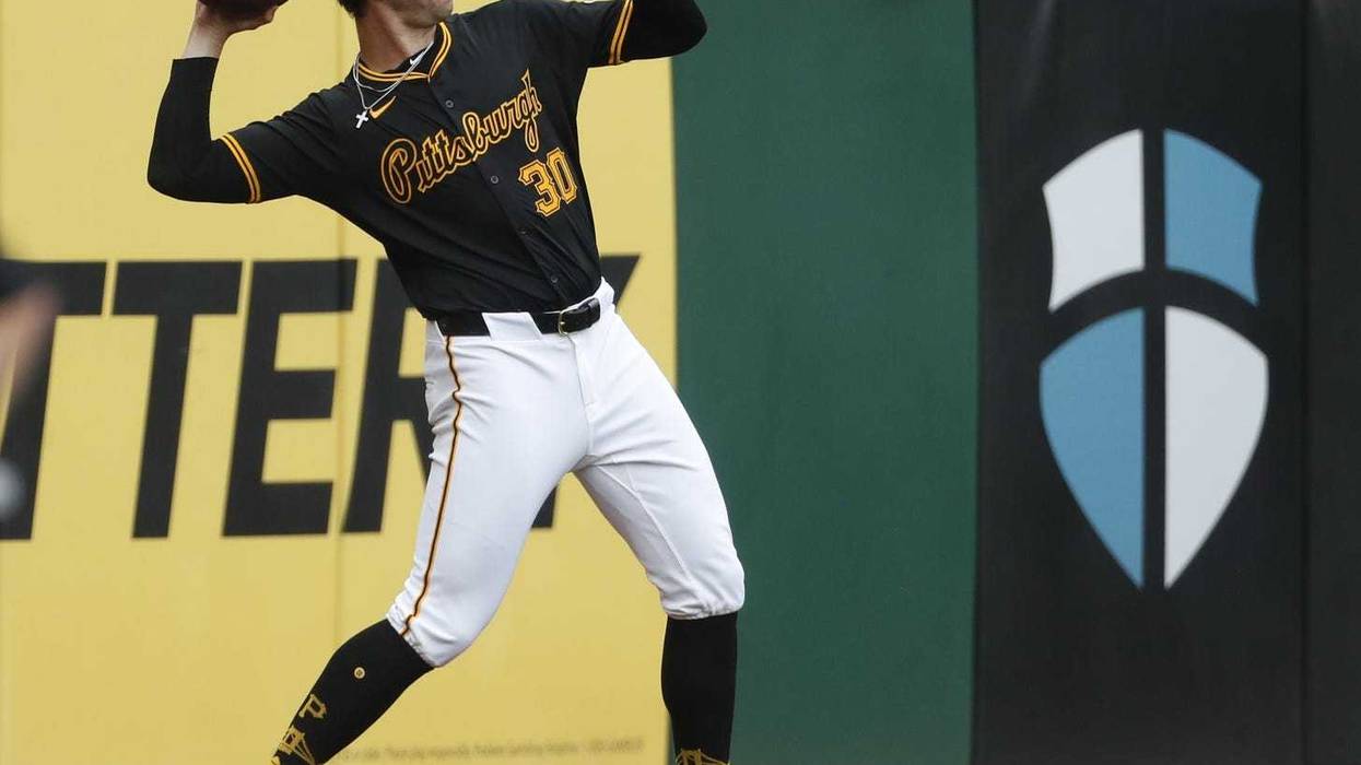 Paul Skenes throwing a football in warmups