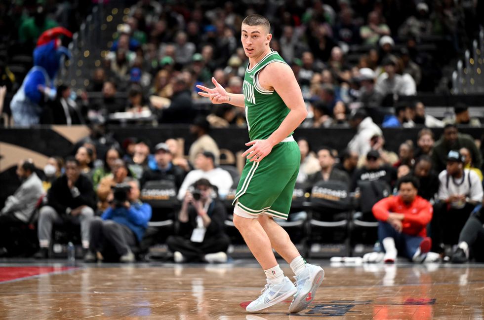 Payton Pritchard #11 of the Boston Celtics celebrates after scoring in the third quarter against the Washington Wizards at Capital One Arena on December 15, 2024 in Washington, DC.