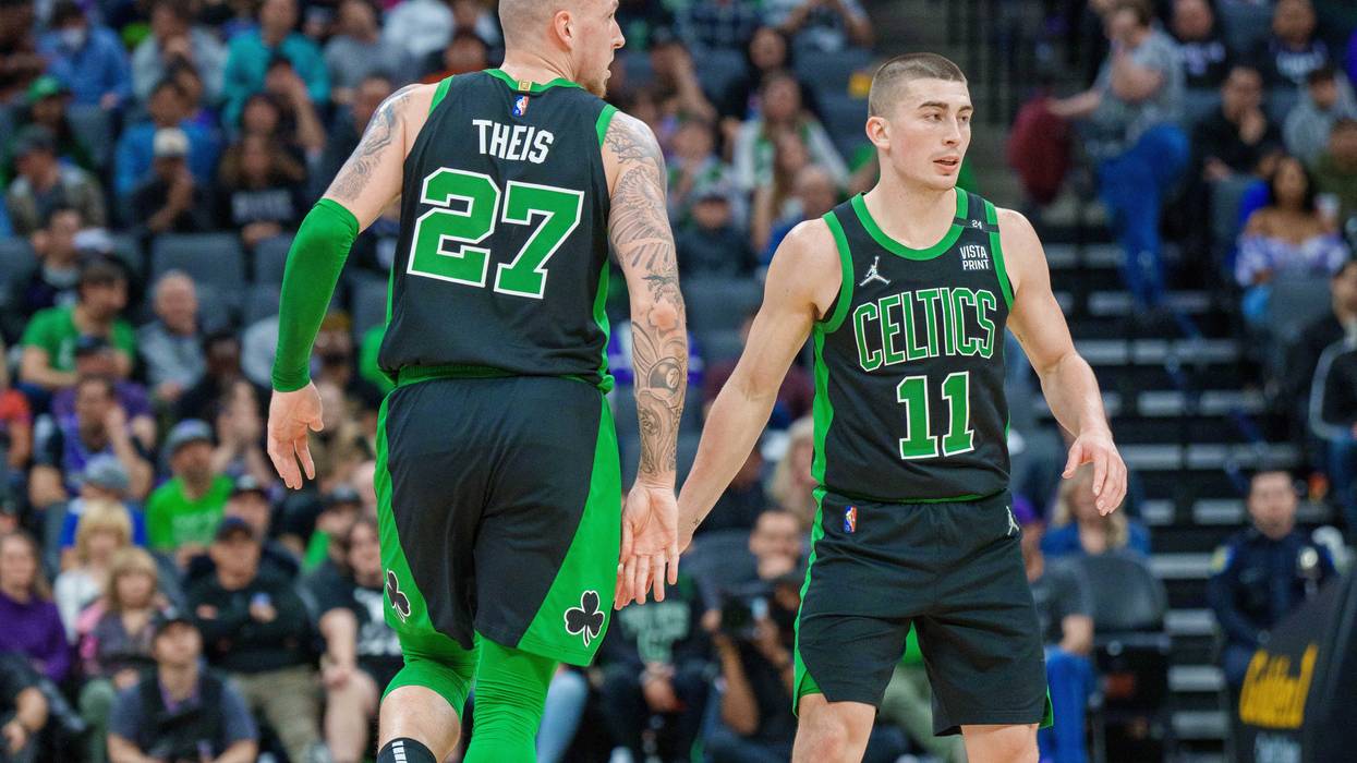 Payton Pritchard connects with Daniel Theis after knocking down a 3-pointer vs. the Kings